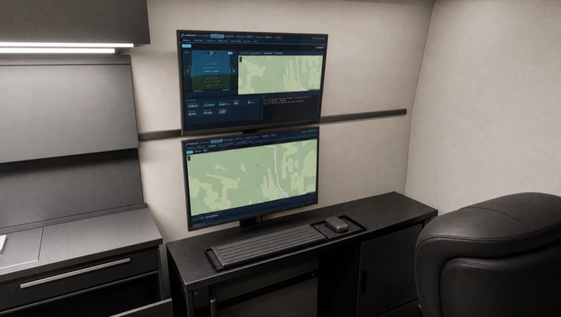 Ground control station: two stacked monitors on the van wall showing the DropForce ground control software.